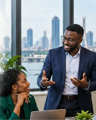 Facilitator leading a discussion with a team in an office overlooking Lagos